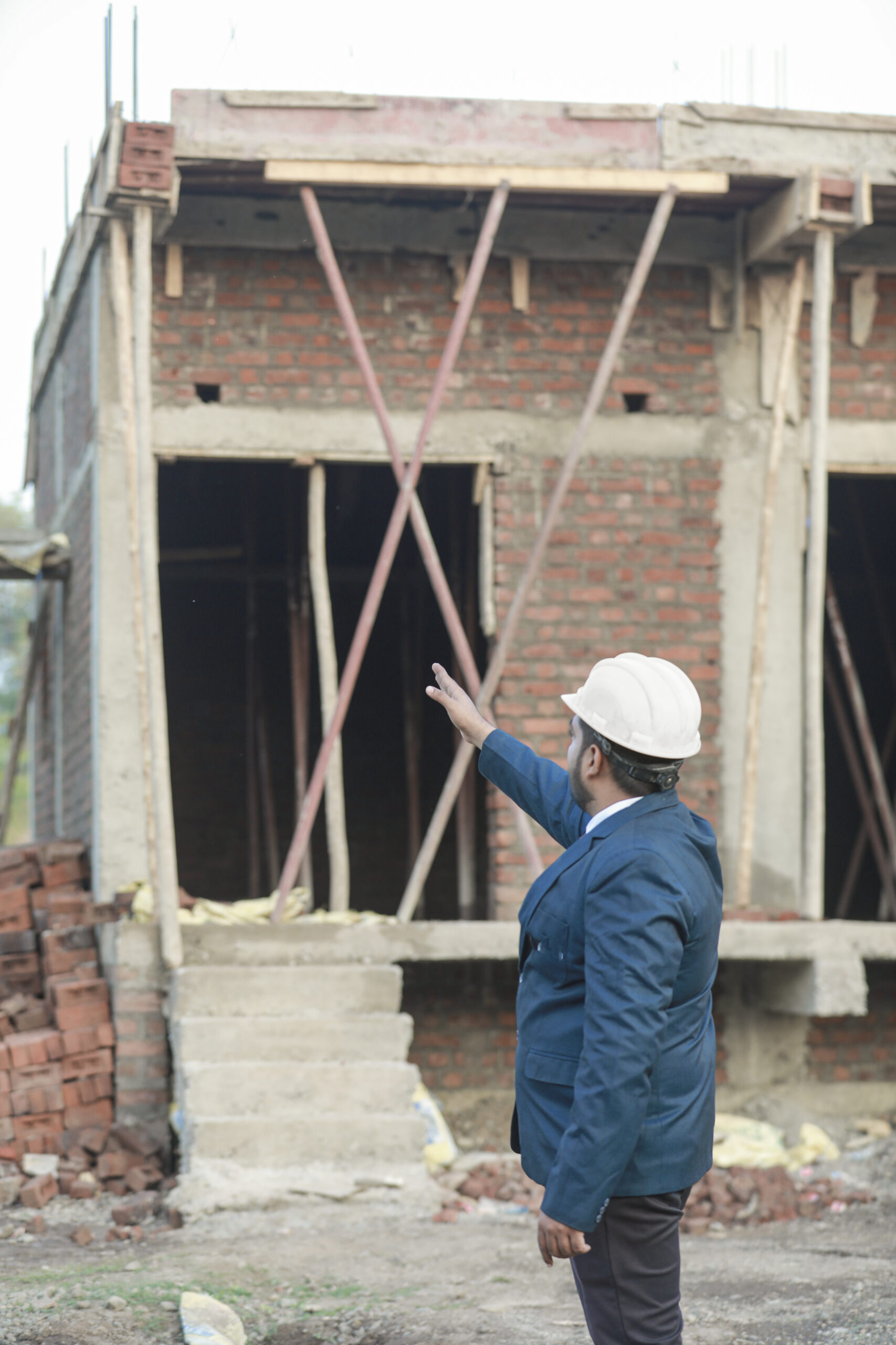 Portrait of civil engineer with safety uniform working at construction site outdoor, Construction worker checking and controlling project on building site, Architecture engineering on new project